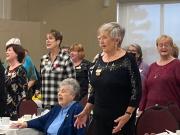 Sea Belles and former members singing for Janet 2